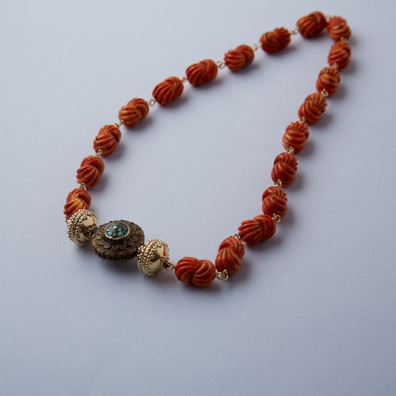 Caspian Apple Coral Carved Knot Necklace